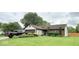 Well maintained home with neat landscaping, green lawn, and a dark truck parked in the driveway at 8123 Summertree Ct, Indianapolis, IN 46256