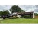 Charming home with a well-manicured lawn, mature landscaping, and a driveway featuring a black truck at 8123 Summertree Ct, Indianapolis, IN 46256