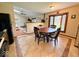 Bright eat-in kitchen features wood table, tile floor, and seamless transition to living room at 8123 Summertree Ct, Indianapolis, IN 46256