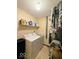 Practical laundry area with washer, dryer, and shelving, designed for efficient home maintenance and organization at 8123 Summertree Ct, Indianapolis, IN 46256