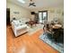 Inviting living room featuring hardwood floors, a ceiling fan, and sliding glass doors to the backyard at 8123 Summertree Ct, Indianapolis, IN 46256