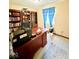 Inviting home office with warm colored walls, stylish built-in bookshelves and comfortable desk perfect for work from home needs at 8123 Summertree Ct, Indianapolis, IN 46256