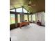 Bright sunroom with large windows, a ceiling fan and neutral accents, providing a tranquil and comfortable space at 8123 Summertree Ct, Indianapolis, IN 46256