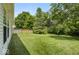 A lush backyard with mature trees and a privacy fence creates a serene outdoor space at 8446 S Paddleboat Ln, Pendleton, IN 46064