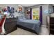 Clean bedroom featuring a full-size bed, neutral walls, and an organized desk at 8446 S Paddleboat Ln, Pendleton, IN 46064