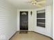 Welcoming front porch with covered ceiling fan and decorative exterior lighting at 8446 S Paddleboat Ln, Pendleton, IN 46064
