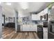 Updated kitchen features stainless steel appliances, white cabinets, and wood-look vinyl flooring at 8446 S Paddleboat Ln, Pendleton, IN 46064