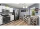 Eat-in kitchen features stainless steel appliances, white cabinetry and a modern dining table at 8446 S Paddleboat Ln, Pendleton, IN 46064