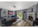 Bright living room featuring a stone fireplace, plush sectional, and a sliding glass door at 8446 S Paddleboat Ln, Pendleton, IN 46064