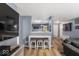 Open-concept living space with a breakfast bar, view into kitchen, and hardwood floors at 8446 S Paddleboat Ln, Pendleton, IN 46064