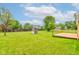 Expansive backyard features a play structure, green grass, and a wood deck at 8684 Captain Dr, Avon, IN 46123
