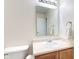 Bathroom featuring neutral walls, vanity, toilet, and mirror at 8684 Captain Dr, Avon, IN 46123