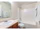 This bathroom has a wood vanity with sink, toilet, and bathtub with shower at 8684 Captain Dr, Avon, IN 46123