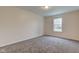 This bedroom has plush carpet and a window bringing in natural light at 8684 Captain Dr, Avon, IN 46123