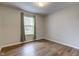 This bedroom features a window with blinds and wood flooring at 8684 Captain Dr, Avon, IN 46123