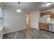 Bright dining area features modern light fixture and view into adjacent kitchen and hallway at 8684 Captain Dr, Avon, IN 46123