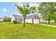 Well-maintained single-story home featuring brick and vinyl siding, blue shutters, and a spacious front lawn at 8684 Captain Dr, Avon, IN 46123