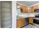 Kitchen featuring stainless steel appliances, wood cabinets, and wood-look flooring at 8684 Captain Dr, Avon, IN 46123
