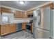 Bright kitchen featuring stainless steel appliances, wood cabinets, and wood-look flooring at 8684 Captain Dr, Avon, IN 46123