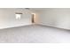 Spacious living room with neutral carpet and view into adjacent kitchen area at 8684 Captain Dr, Avon, IN 46123
