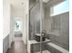 Modern bathroom showcasing a glass enclosed shower and sleek grey tiling at 8684 Marietta Ln, McCordsville, IN 46055