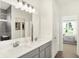 A well-lit bathroom featuring double sinks and modern fixtures at 8684 Marietta Ln, McCordsville, IN 46055