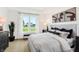 A sunlit bedroom with contemporary decor, large window, and neutral color palette at 8684 Marietta Ln, McCordsville, IN 46055