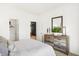 Bright bedroom featuring a rustic wood dresser, ensuite access, and neutral decor at 8684 Marietta Ln, McCordsville, IN 46055