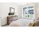 Bright bedroom featuring a wooden dresser, modern decor, and a large window with natural light at 8684 Marietta Ln, McCordsville, IN 46055