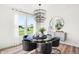 Bright dining room featuring a modern chandelier, neutral decor, and large windows at 8684 Marietta Ln, McCordsville, IN 46055