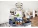 Open dining area with stylish chandelier, modern decor, and an open view of the gourmet kitchen at 8684 Marietta Ln, McCordsville, IN 46055