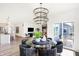 Bright dining area with a modern chandelier, open to the kitchen and featuring sliding glass door at 8684 Marietta Ln, McCordsville, IN 46055