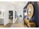 Spacious hallway with wood-look floors, blue accent wall and views into adjacent rooms at 8684 Marietta Ln, McCordsville, IN 46055