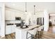 Bright kitchen featuring white cabinetry, stainless appliances, and a granite-topped center island at 8684 Marietta Ln, McCordsville, IN 46055