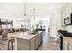 Open concept kitchen with a center island, stainless steel appliances, and views into the living room at 8684 Marietta Ln, McCordsville, IN 46055