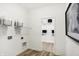 Bright laundry room with open shelving, linen storage and a view into another walk-in closet at 8684 Marietta Ln, McCordsville, IN 46055