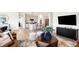 Open-concept living room flowing into the modern kitchen and dining area with stylish decor at 8684 Marietta Ln, McCordsville, IN 46055
