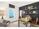 Bright home office with a large window, dark accent wall, and modern decor at 8684 Marietta Ln, McCordsville, IN 46055