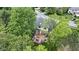 Aerial view of a home with a wooden deck nestled among mature trees in a quiet neighborhood at 8723 Bergeson Dr, Indianapolis, IN 46278