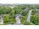 Aerial shot of a brick home, featuring a well-kept lawn, attached garage, and tree-lined street in the background at 8723 Bergeson Dr, Indianapolis, IN 46278
