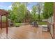 Large wooden deck including an outdoor dining set, grill, and outdoor storage at 8723 Bergeson Dr, Indianapolis, IN 46278