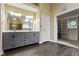 Bathroom with a double sink vanity, a large mirror, and a walk-in closet in the background at 8723 Bergeson Dr, Indianapolis, IN 46278