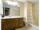 Bright bathroom with a shower-tub combo, single sink vanity, and decorative shower curtain at 8723 Bergeson Dr, Indianapolis, IN 46278