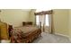Cozy bedroom with carpet, plaid bedding, window, and vintage furniture accents at 8723 Bergeson Dr, Indianapolis, IN 46278