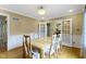 Elegant dining room featuring wainscoting, hardwood floors, and french doors leading to another room at 8723 Bergeson Dr, Indianapolis, IN 46278