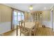 Elegant dining room featuring wainscoting, hardwood floors, and a large window with curtains at 8723 Bergeson Dr, Indianapolis, IN 46278