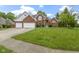 Beautiful brick two-story home featuring an attached two-car garage and a well-manicured lawn at 8723 Bergeson Dr, Indianapolis, IN 46278