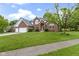 Beautiful brick two-story home featuring an attached two-car garage and a well-manicured lawn at 8723 Bergeson Dr, Indianapolis, IN 46278