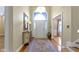 Inviting foyer with hardwood floors, an arched doorway, and a chandelier hanging from the ceiling at 8723 Bergeson Dr, Indianapolis, IN 46278