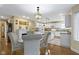 Eat-in kitchen featuring white cabinets, granite countertops, and stylish pendant lighting at 8723 Bergeson Dr, Indianapolis, IN 46278